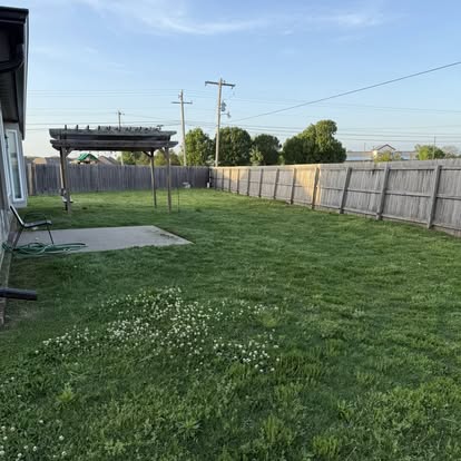 Backyard with pergola and fresh cut grass